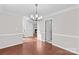 Dining room with hardwood-style floors and chandelier; adjacent to the living room with fireplace at 1807 Sugar Hollow Dr, Charlotte, NC 28214