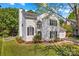 Beautiful white home with black shutters, green lawn, and flower beds at 1807 Sugar Hollow Dr, Charlotte, NC 28214