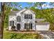 Charming two-story home boasts a manicured lawn, black shutters, and attached two car garage at 1807 Sugar Hollow Dr, Charlotte, NC 28214