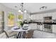 Bright eat-in kitchen featuring white cabinets, stainless steel appliances, and a sunlit breakfast nook at 1807 Sugar Hollow Dr, Charlotte, NC 28214