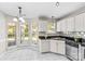 Bright kitchen with white cabinets, stainless steel appliances, granite countertops, and eat-in breakfast nook at 1807 Sugar Hollow Dr, Charlotte, NC 28214