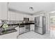 Well-lit kitchen with stainless steel appliances, white cabinetry, and sleek countertops at 1807 Sugar Hollow Dr, Charlotte, NC 28214