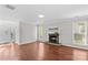Bright living room with hardwood floors, a fireplace, and large windows for natural light at 1807 Sugar Hollow Dr, Charlotte, NC 28214