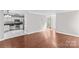 Open-concept layout with hardwood-style floors seamlessly connects the living room to the adjacent kitchen at 1807 Sugar Hollow Dr, Charlotte, NC 28214