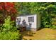 A storage shed is nestled among mature trees in the backyard at 1807 Sugar Hollow Dr, Charlotte, NC 28214