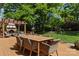 Outdoor deck with a dining set, a fireplace, and a view of the well-maintained backyard at 1816 5Th Nw St, Hickory, NC 28601