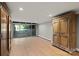 Large basement area featuring wood floors, sliding glass doors, and a decorative wooden armoire at 1816 5Th Nw St, Hickory, NC 28601