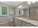 Bright bathroom featuring dual granite sinks, large mirror, and window with shutter for natural light at 1816 5Th Nw St, Hickory, NC 28601