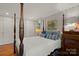 Cozy bedroom with four poster bed, wood floors, and custom built in wardrobe at 1816 5Th Nw St, Hickory, NC 28601