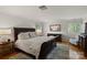 Spacious bedroom with hardwood floors, a dresser, and bright neutral colored walls at 1816 5Th Nw St, Hickory, NC 28601