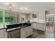 Well-lit kitchen boasts black countertops, stainless steel appliances and backyard views at 1816 5Th Nw St, Hickory, NC 28601