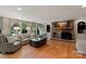 Bright and airy living room featuring hardwood floors, stone fireplace, and arched windows at 1816 5Th Nw St, Hickory, NC 28601