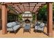Relaxing outdoor space with a stone fireplace, comfortable seating, and pergola for shade at 1816 5Th Nw St, Hickory, NC 28601