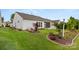 Well-maintained backyard with lush lawn, mature landscaping, and a view of the home's screened porch at 20135 Dovekie Ln, Fort Mill, SC 29707
