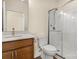 Bathroom featuring wood cabinet, granite countertop, toilet, and glass enclosed shower at 20135 Dovekie Ln, Fort Mill, SC 29707