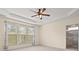 Bright bedroom with ceiling fan, tray ceiling, large window, and ensuite bathroom entrance on right side at 20135 Dovekie Ln, Fort Mill, SC 29707