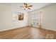 Bedroom featuring hardwood floors, a ceiling fan, and natural light from a window overlooking the kitchen at 20135 Dovekie Ln, Fort Mill, SC 29707