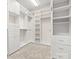 Spacious walk-in closet with built in shelves and drawers and carpeted floor at 20135 Dovekie Ln, Fort Mill, SC 29707