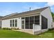 Exterior of the home showing the screened-in porch, vinyl siding, and mature landscaping at 20135 Dovekie Ln, Fort Mill, SC 29707
