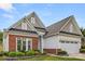 Charming single-story home with brick and siding exterior, manicured lawn, and attached two-car garage at 20135 Dovekie Ln, Fort Mill, SC 29707