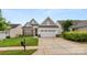 Charming home featuring a well-manicured lawn, brick accents, and an attached two-car garage at 20135 Dovekie Ln, Fort Mill, SC 29707