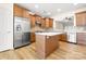 Spacious kitchen includes wood cabinets, stainless steel appliances, tiled backsplash, and an island at 20135 Dovekie Ln, Fort Mill, SC 29707