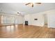 Expansive living room featuring wood-look floors, fireplace, ceiling fans and plenty of natural light at 20135 Dovekie Ln, Fort Mill, SC 29707