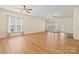 Bright living room features wood floors, ceiling fans, fireplace, and ample windows offering natural light at 20135 Dovekie Ln, Fort Mill, SC 29707