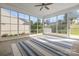 Bright sunroom featuring large windows offering views of the outdoors and a ceiling fan for comfort at 20135 Dovekie Ln, Fort Mill, SC 29707