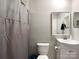 Bathroom features a shower with a gray shower curtain, toilet, and a vanity with a mirror at 2113 Killarney Pl, Charlotte, NC 28262