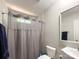 Bathroom features a shower with a gray shower curtain, toilet, and a vanity with mirror at 2113 Killarney Pl, Charlotte, NC 28262