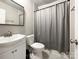 Neutral bathroom featuring a shower with curtain, standard toilet and sink at 2113 Killarney Pl, Charlotte, NC 28262