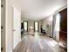 Bedroom with light grey walls, vinyl floors, desk, and windows providing natural light at 2113 Killarney Pl, Charlotte, NC 28262