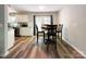 Bright dining area with hardwood floors, modern table, and access to the outdoor patio at 2113 Killarney Pl, Charlotte, NC 28262