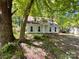 Charming two-story home with white siding and mature trees providing shade at 2113 Killarney Pl, Charlotte, NC 28262