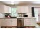 Bright kitchen features white cabinets, granite countertops, stainless steel appliances, and a sink under a window at 2113 Killarney Pl, Charlotte, NC 28262