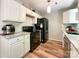 Modern kitchen features white cabinets, stainless steel appliances, and hardwood floors at 2113 Killarney Pl, Charlotte, NC 28262
