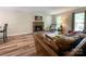 Cozy living room with a brick fireplace, hardwood floors, and plenty of natural light at 2113 Killarney Pl, Charlotte, NC 28262