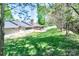 Sprawling backyard with lush green lawn, a gazebo, and mature trees along the perimeter at 212 Brookwood Dr, Salisbury, NC 28146