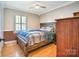 Bedroom with hardwood floors, a ceiling fan, and a bed frame made of rustic wood at 212 Brookwood Dr, Salisbury, NC 28146