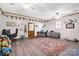 Large bonus room with hardwood floors, several ceiling fans, and a large area rug at 212 Brookwood Dr, Salisbury, NC 28146