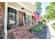 Inviting front porch with rocking chairs and an American flag, framed by a brick facade at 212 Brookwood Dr, Salisbury, NC 28146
