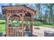 Outdoor gazebo with seating, set in a backyard with manicured lawn and a fire pit at 212 Brookwood Dr, Salisbury, NC 28146
