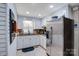 Well-lit kitchen with stainless steel appliances, granite countertops, and tile flooring at 212 Brookwood Dr, Salisbury, NC 28146