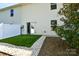 A fully fenced backyard with a small artificial-turf area and stone borders at 2141 Talbert Ct, Charlotte, NC 28214