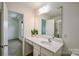 Bright bathroom with a large mirror, white vanity and view into another room at 2141 Talbert Ct, Charlotte, NC 28214