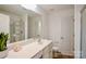 Well-lit bathroom with a large mirror, white vanity, and walk-in shower with glass doors at 2141 Talbert Ct, Charlotte, NC 28214