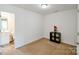 Neutral bedroom featuring adjoined bathroom, floral accent and minimal furnishings at 2141 Talbert Ct, Charlotte, NC 28214