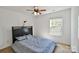 Neutral bedroom featuring a dark wood headboard, ceiling fan and view to neighborhood at 2141 Talbert Ct, Charlotte, NC 28214