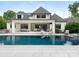 Spectacular backyard with a pool, outdoor living area, and lush landscaping at 2343 Vernon Dr, Charlotte, NC 28211
